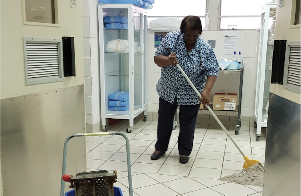 Ms. De Bruin, who has worked as a passionate and dedicated environmental cleaning staff for over 40 years at a hospital in Cape Town, South Africa demonstrates best practices for mopping floors in a patient care area. Photo credit: CDC