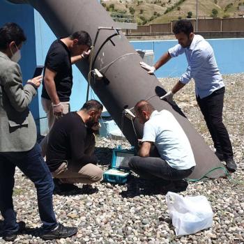 Staff of the Soran Water Directorate use ultrasonic flowmeters to measure the water flow through a main distribution pipe. Photo credit: WADA Tajdid Project