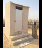 A homeowner poses with a new ventilated improved double pit latrine for high-level water tables built on one of Senegal’s remote Saloum Islands. Photo credit: Theophane Boutrolle