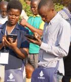 Data technicians in the Manica province of Mozambique at a training to learn how to use the new m-SINAS tablets for mobile data collection under the IWED Mozambique program. Photo Credit: ENGIDRO